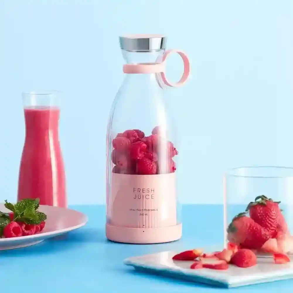 Portable blender being used to make a smoothie, showcasing its convenience and portability